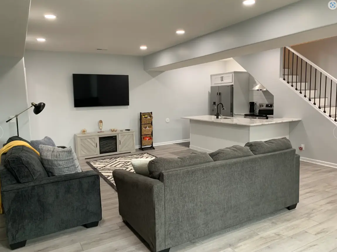 Finished basement with lounge seating and built-ins