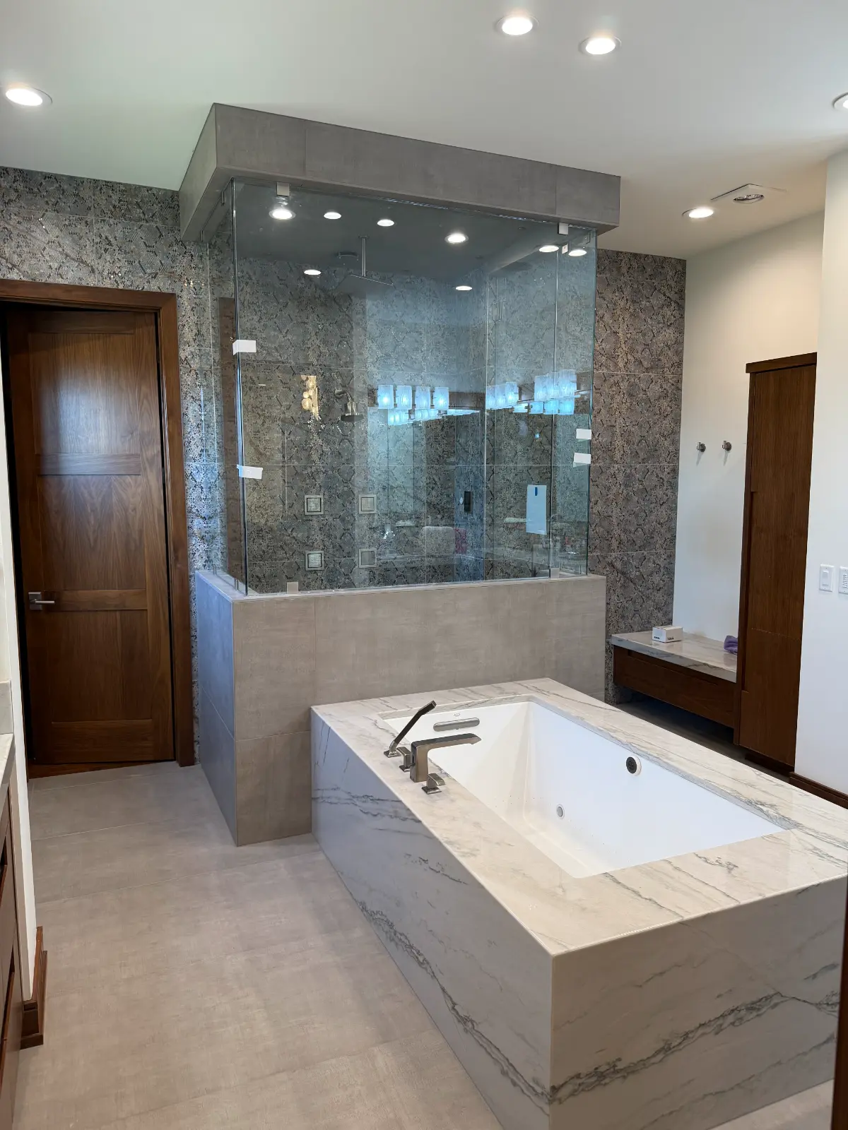 Finished bathroom with tile shower and custom vanity